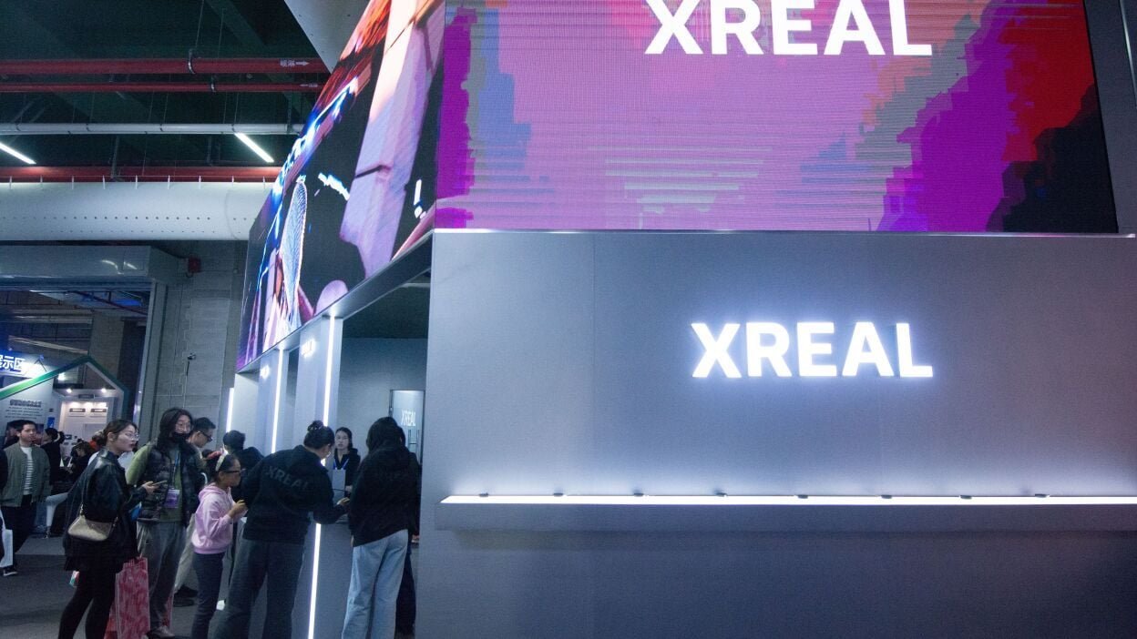 a crowd gathers at an XREAL booth at a tech convention